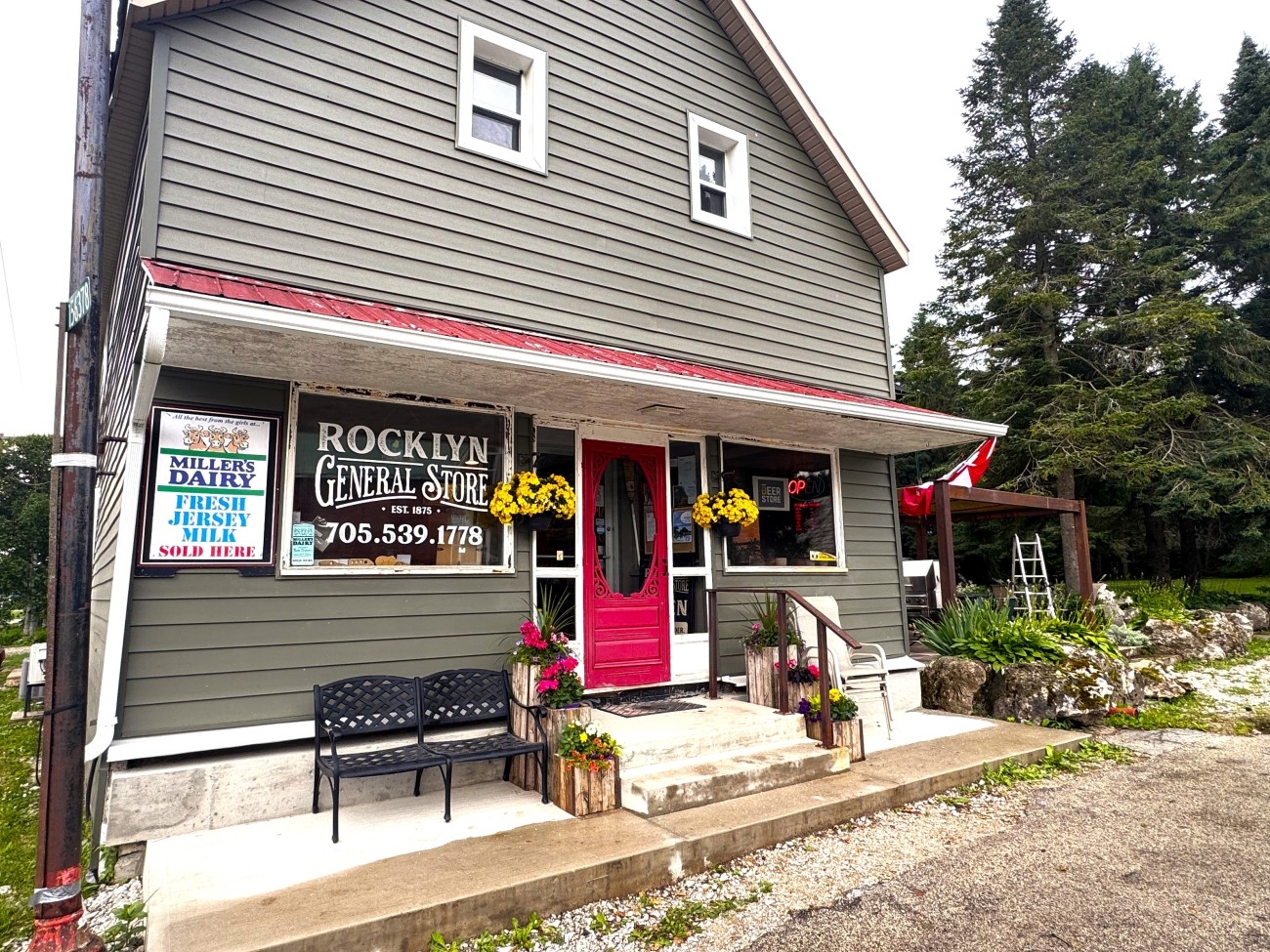 Exterior of a store with green-grey siding.
