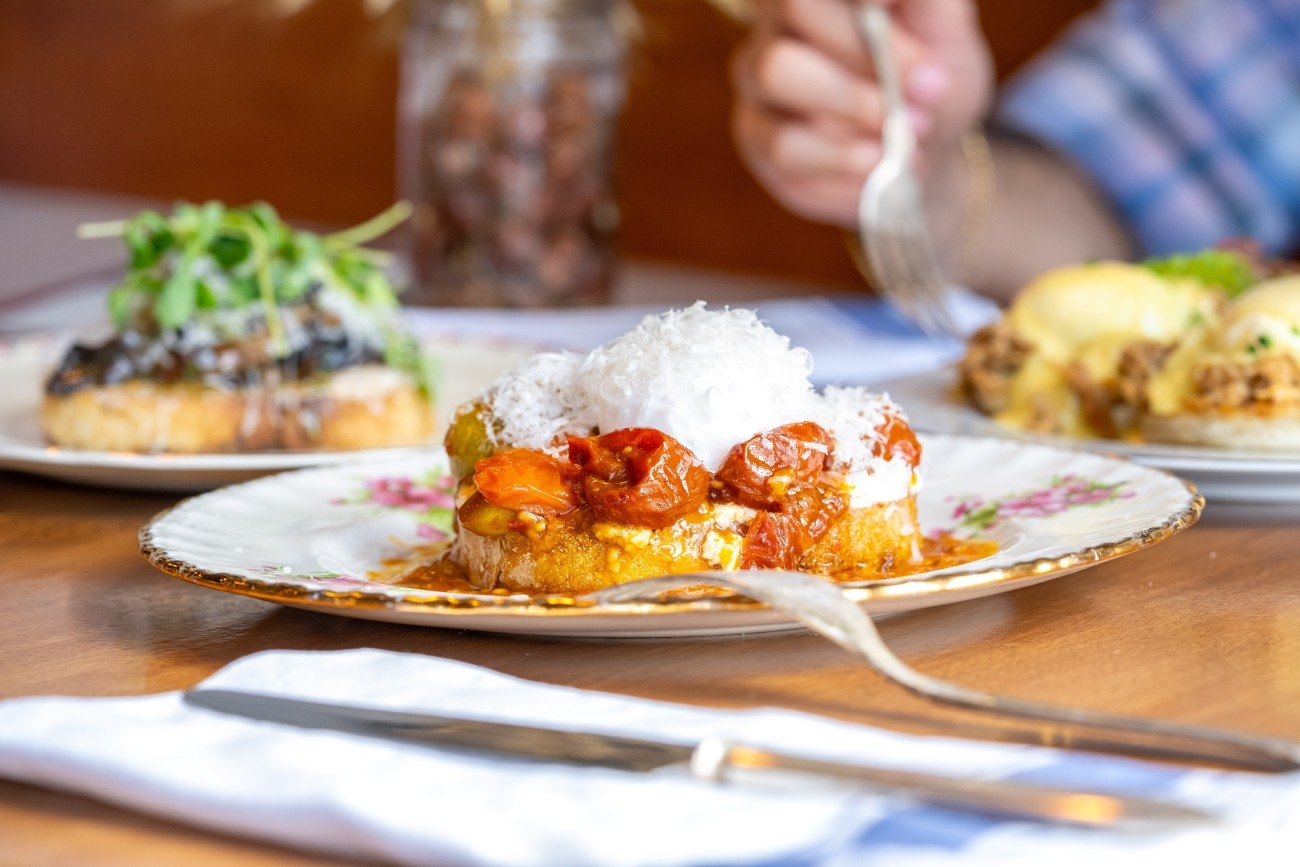 Close shot of a plated dish with tomatoes and parmesan.