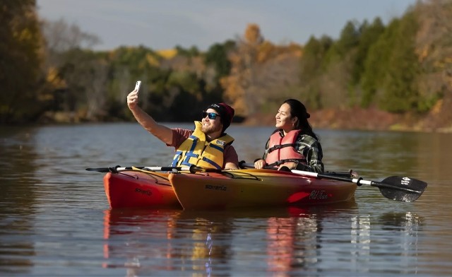 Two kayakers pose for a selfie.