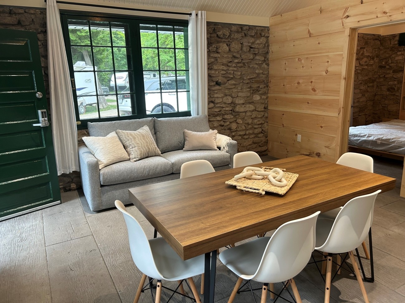 Finished interior of cabin with stone walls.