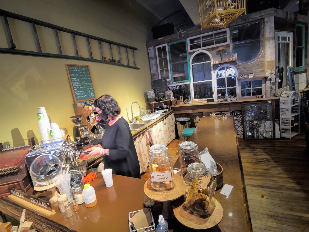 A barista prepares coffee in a cafe.