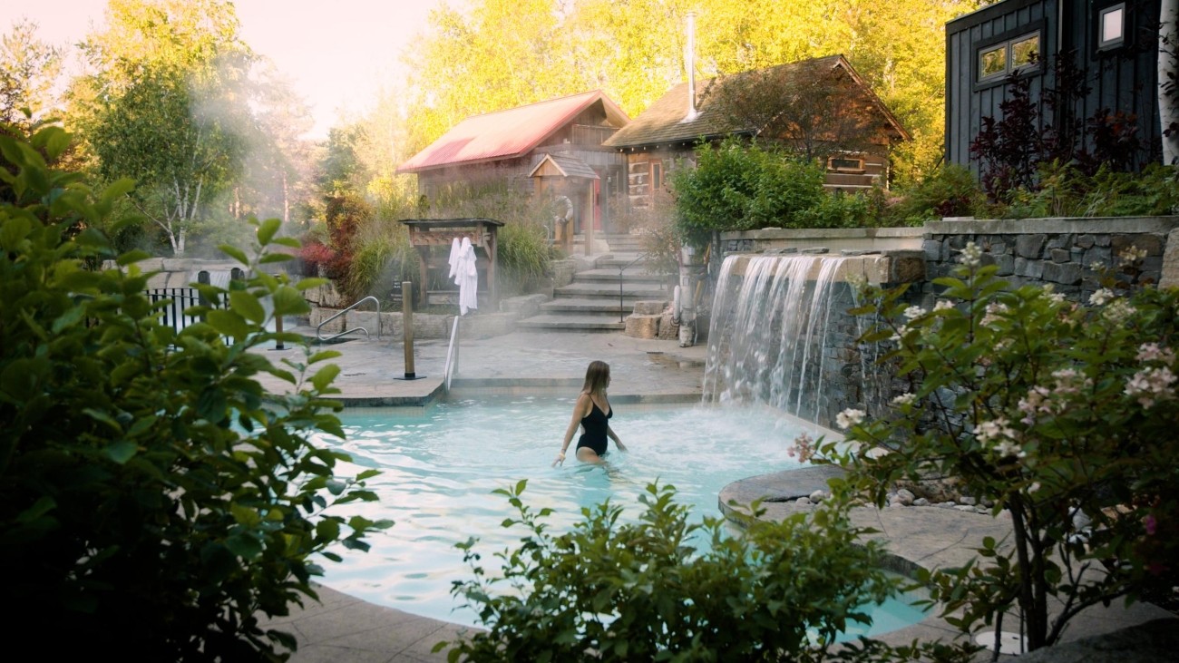 Woman in hot pool with waterfalls