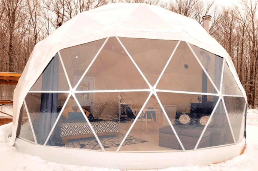 Exterior of a large dome tent in winter.