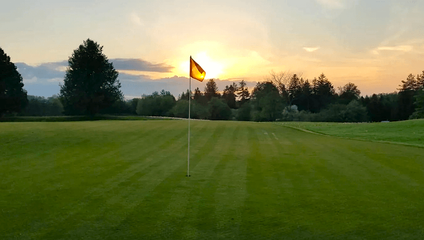 the green on a golf course at sunset 