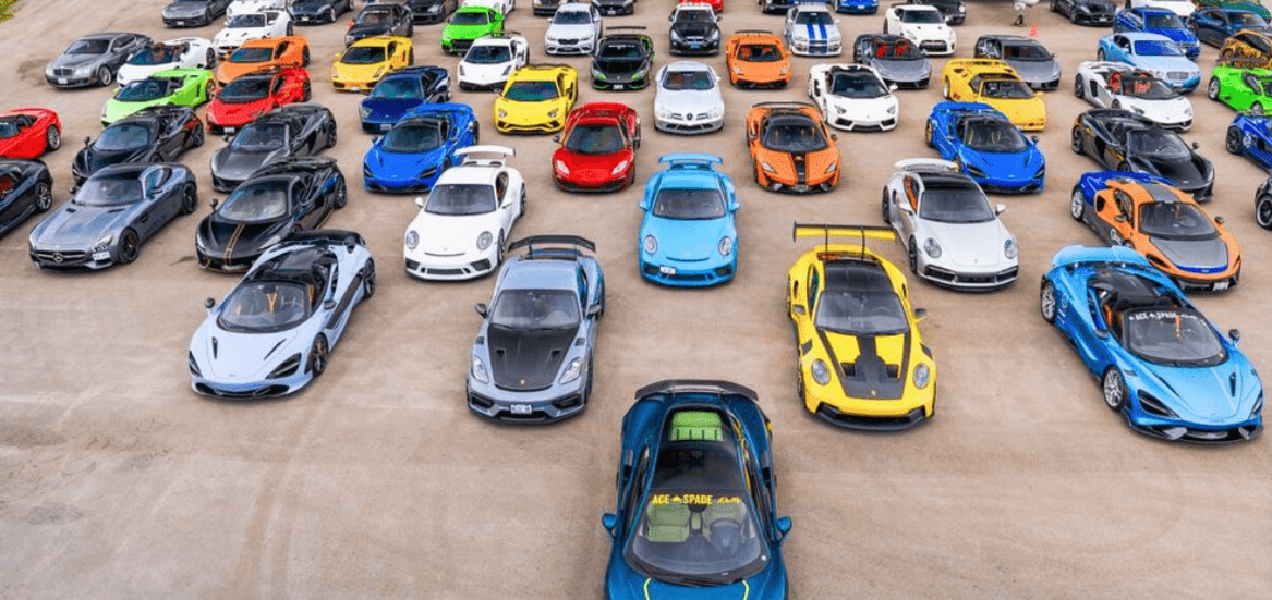 Aerial view of numerous sportscars in a parking lot.